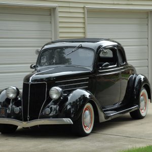 When Jerry Nichols isn’t working on his myriad projects, he’s out motoring in his neat ’36 Ford five-window coupe. The black coupe rolls on orange steelies wrapped with wide whitewalls. We like everything about this coupe, from the stock roof insert and headlights to the smooth running boards; the car has a great look.