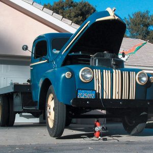 Yes, that’s an electric scissor jack under this 2 1/2-ton truck. It is designed to jack up your car to change a flat tire, but will it lift your street rod? (Note the air under both front wheels.)