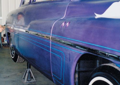 The work on the lower side scallop comes next. The long lines are pulled from the front reference point to the rear reference point. If your first attempt on a super-long line has a dip, pull it loose from the rear, make it taut and try again. The more you practice, the easier it becomes. It also helps to elevate the car when laying out the lower lines. By getting the car up in the air, you’ll easily be able to look from the front to the rear and know that the lines are perfect.