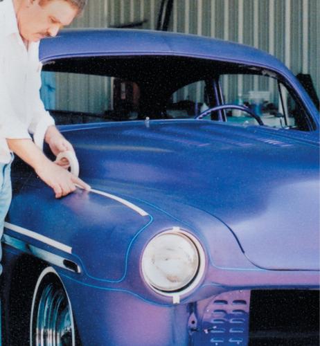 Once all of the 1/8-inch lines are finalized, 3/4-inch tape is placed over them to establish a broader base for attaching the masking paper. This also helps ensure that no paint will run or blow under the thin masking tape edges. Keep the 1/8-inch tape as the active paint edge by placing the 3/4-inch tape half way over the 1/8-inch tape. Be careful not to allow the larger tape to enter the painted portion of the pattern. 